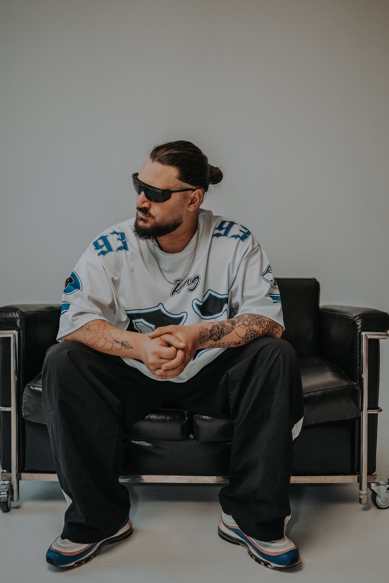 BESSARIONN seated wearing sunglasses