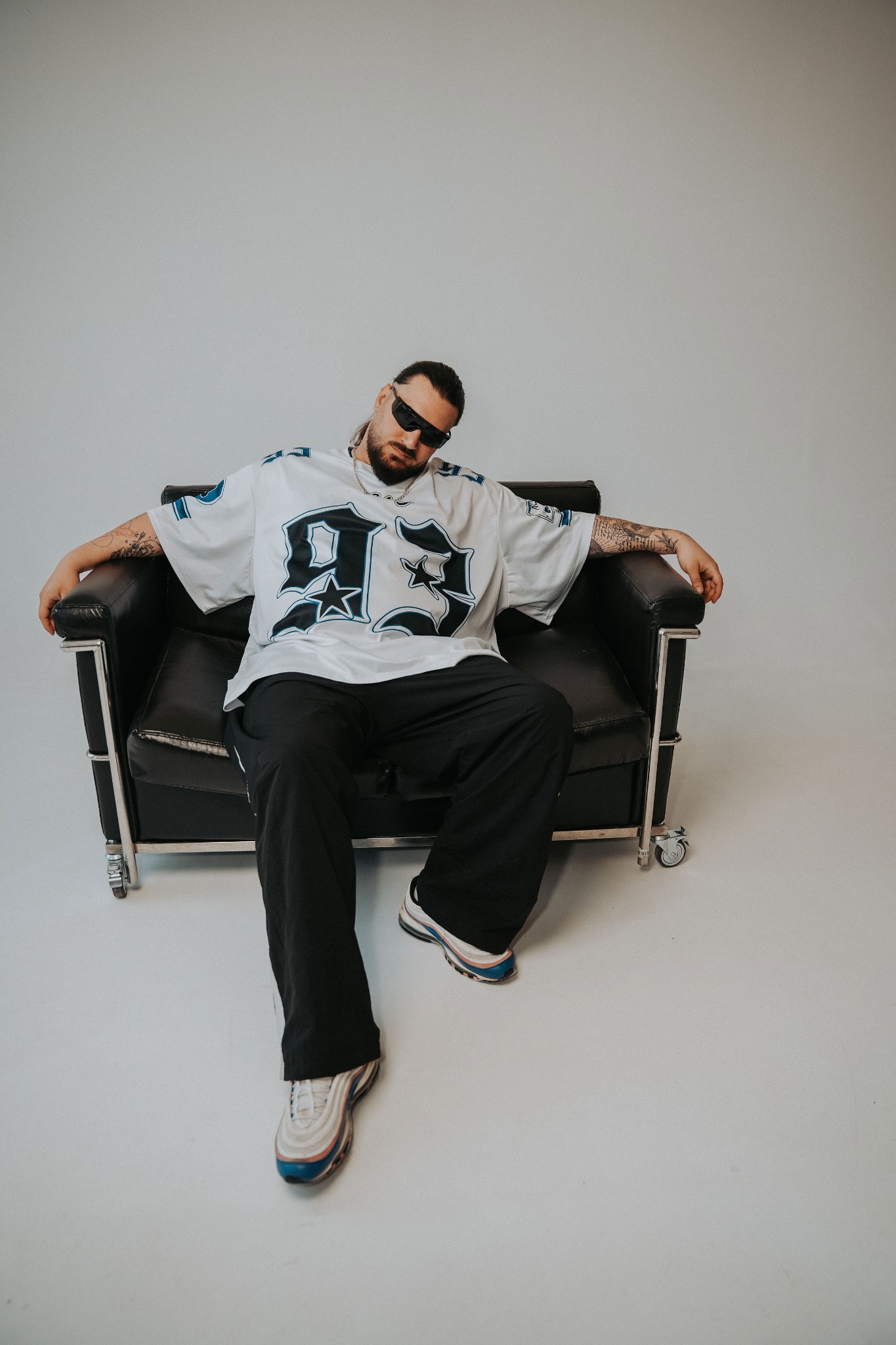 BESSARIONN reclining in a studio chair